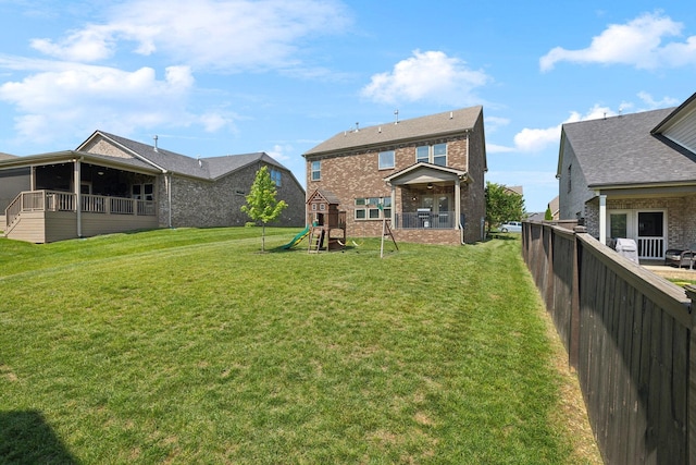 633 Fall Creek Cir, Goodlettsville, TN 37072 - rear view of property featuring a playground and brick siding