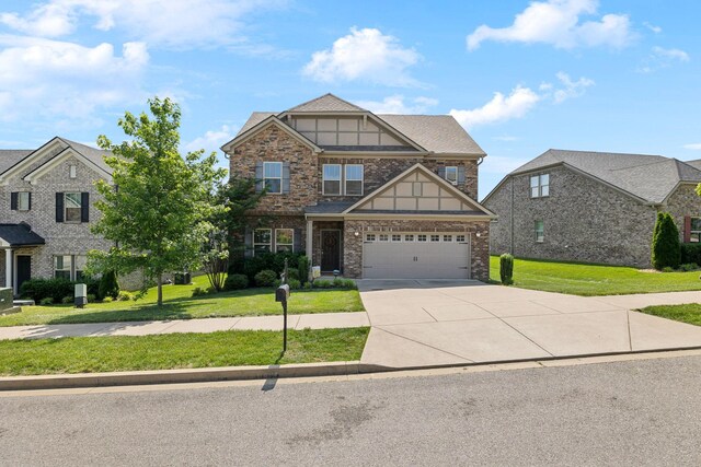 633 Fall Creek Cir, Goodlettsville, TN 37072 - craftsman-style home featuring driveway, a garage, a front yard, and brick siding