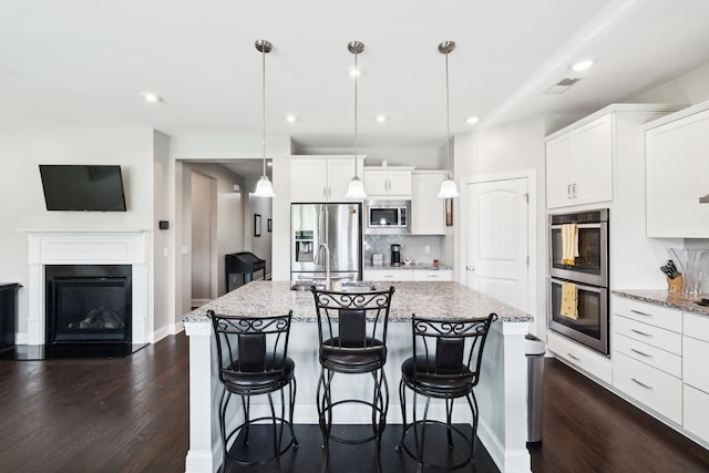 633 Fall Creek Cir, Goodlettsville, TN 37072 - kitchen featuring appliances with stainless steel finishes, dark wood-style flooring, white cabinetry, and recessed lighting