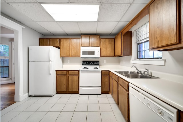 504 Macfie Ct, Madison, TN 37115 - kitchen with white appliances, a sink, brown cabinetry, a paneled ceiling, and light countertops