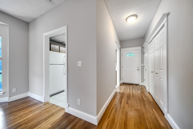 504 Macfie Ct, Madison, TN 37115 - corridor featuring a textured ceiling, wood finished floors, and baseboards