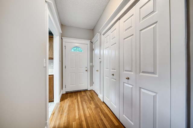 504 Macfie Ct, Madison, TN 37115 - doorway featuring light wood-style floors, a textured ceiling, and baseboards