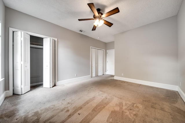 504 Macfie Ct, Madison, TN 37115 - unfurnished bedroom with two closets, carpet floors, baseboards, a textured ceiling, and ceiling fan