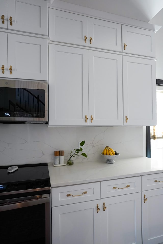 173 Tulip Grove Pt, Hermitage, TN 37076 - kitchen with stainless steel appliances, decorative backsplash, and white cabinets