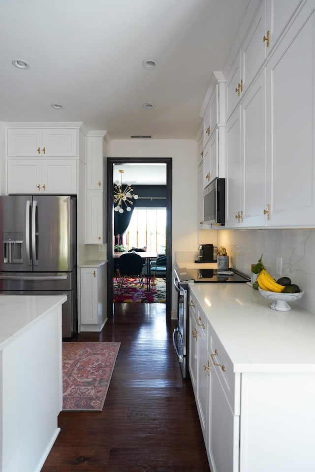 173 Tulip Grove Pt, Hermitage, TN 37076 - kitchen featuring stainless steel appliances, dark wood-type flooring, white cabinetry, decorative backsplash, and light countertops