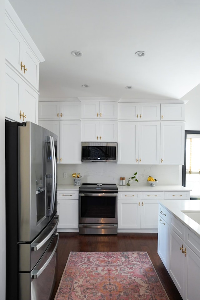173 Tulip Grove Pt, Hermitage, TN 37076 - kitchen with stainless steel appliances, light countertops, white cabinetry, dark wood finished floors, and recessed lighting