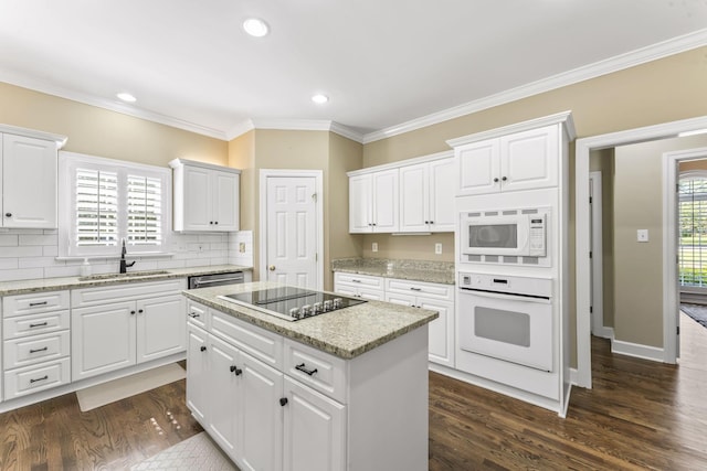 3000 General Forrest Dr, Columbia, TN 38401 - kitchen with white appliances, a sink, a kitchen island, crown molding, and dark wood-type flooring