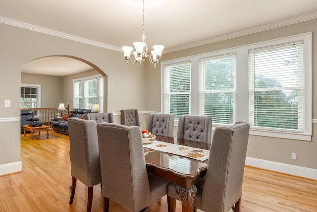 484 E View Dr, Chattanooga, TN 37404 - dining area with arched walkways, a chandelier, light wood-style floors, crown molding, and baseboards