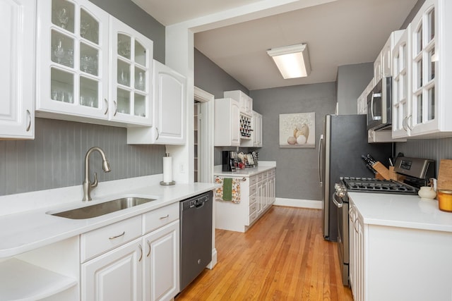 484 E View Dr, Chattanooga, TN 37404 - kitchen with stainless steel appliances, a sink, white cabinets, light wood-style floors, and light countertops