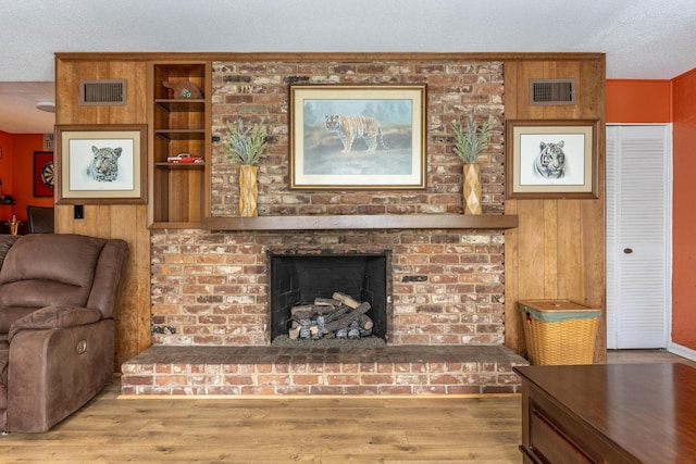 484 E View Dr, Chattanooga, TN 37404 - living room with wood finished floors, a brick fireplace, and a textured ceiling