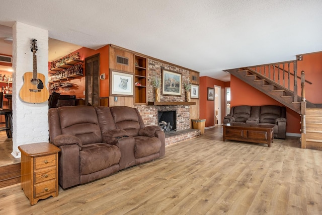 484 E View Dr, Chattanooga, TN 37404 - living room featuring wood finished floors, stairway, a textured ceiling, baseboards, and a brick fireplace