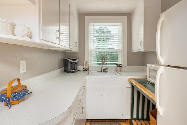484 E View Dr, Chattanooga, TN 37404 - kitchen featuring white appliances, a sink, white cabinetry, light countertops, and a textured ceiling