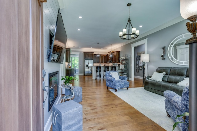 105 Andrews Dr, Loretto, TN 38469 - living room featuring a chandelier, crown molding, light wood finished floors, recessed lighting, and baseboards