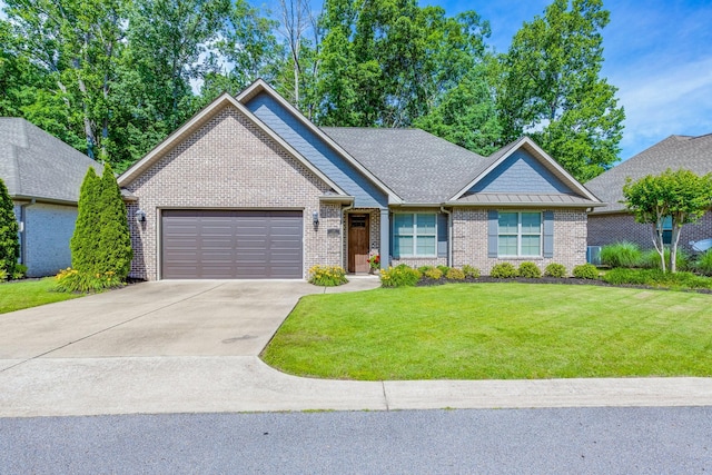 105 Andrews Dr, Loretto, TN 38469 - view of front of property with an attached garage, brick siding, driveway, and a front lawn