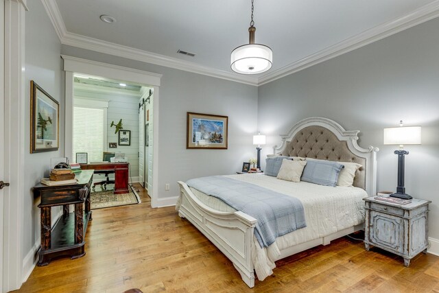 105 Andrews Dr, Loretto, TN 38469 - bedroom featuring light wood-style floors, crown molding, baseboards, and connected bathroom