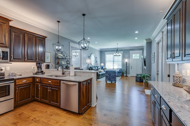 105 Andrews Dr, Loretto, TN 38469 - kitchen with stainless steel appliances, a sink, light wood-style floors, a chandelier, and recessed lighting