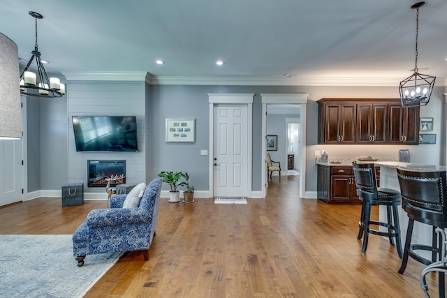 105 Andrews Dr, Loretto, TN 38469 - living room with a chandelier, ornamental molding, wood finished floors, a fireplace, and recessed lighting