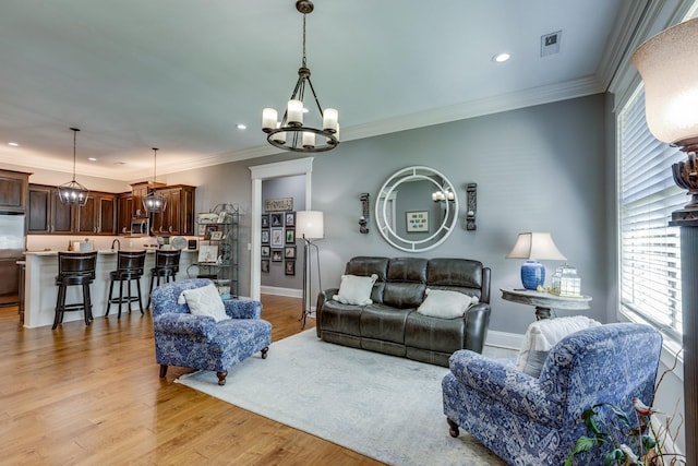 105 Andrews Dr, Loretto, TN 38469 - living room with a chandelier, plenty of natural light, recessed lighting, crown molding, and light wood finished floors