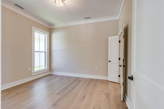 110 4th Ave S, Loretto, TN 38469 - spare room featuring crown molding, healthy amount of natural light, light wood-style floors, and baseboards