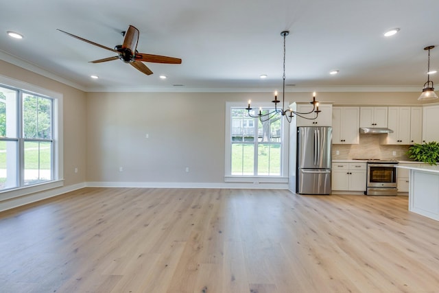 110 4th Ave S, Loretto, TN 38469 - kitchen with appliances with stainless steel finishes, ornamental molding, healthy amount of natural light, under cabinet range hood, and light countertops
