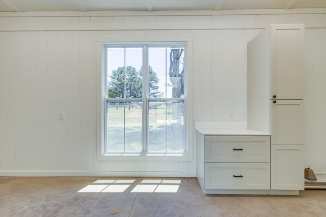 110 4th Ave S, Loretto, TN 38469 - entryway featuring healthy amount of natural light, unfinished concrete flooring, and wooden walls