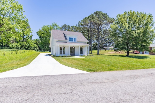 110 4th Ave S, Loretto, TN 38469 - view of front of house featuring concrete driveway, a front lawn, and covered porch
