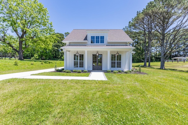 110 4th Ave S, Loretto, TN 38469 - modern farmhouse style home featuring french doors, a front yard, and a shingled roof