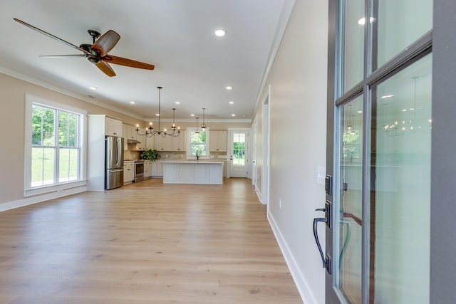 110 4th Ave S, Loretto, TN 38469 - unfurnished living room with crown molding, light wood-type flooring, a ceiling fan, a sink, and baseboards