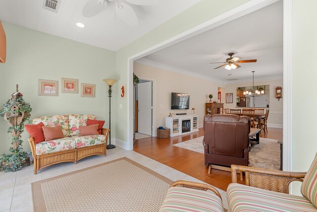 565 Scout Dr, Mount Juliet, TN 37122 - tiled living room with ceiling fan, ornamental molding, a chandelier, a fireplace, and baseboards