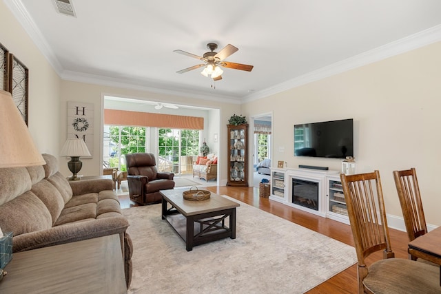 565 Scout Dr, Mount Juliet, TN 37122 - living room with ornamental molding, a ceiling fan, wood finished floors, baseboards, and a glass covered fireplace