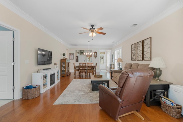 565 Scout Dr, Mount Juliet, TN 37122 - living room featuring a ceiling fan, ornamental molding, wood finished floors, and a chandelier