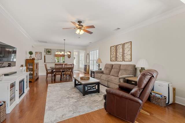 565 Scout Dr, Mount Juliet, TN 37122 - living area with a ceiling fan, crown molding, wood finished floors, a chandelier, and baseboards