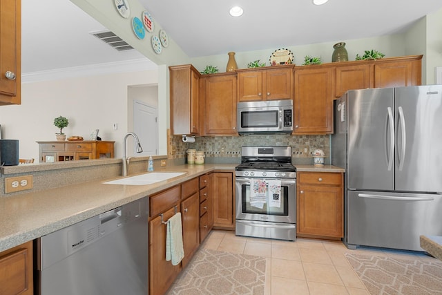 565 Scout Dr, Mount Juliet, TN 37122 - kitchen featuring appliances with stainless steel finishes, a sink, brown cabinetry, light countertops, and crown molding