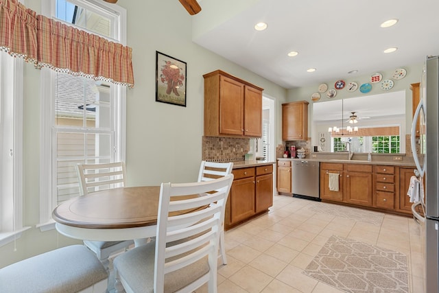 565 Scout Dr, Mount Juliet, TN 37122 - kitchen featuring appliances with stainless steel finishes, brown cabinetry, backsplash, light tile patterned flooring, and ceiling fan