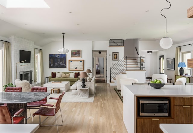 2300 Chickering Ln, Nashville, TN 37215 - kitchen featuring stainless steel microwave, open floor plan, light wood finished floors, light countertops, and lofted ceiling