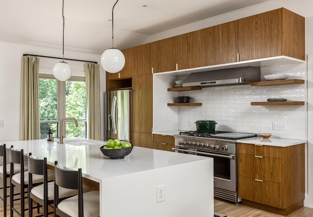 2300 Chickering Ln, Nashville, TN 37215 - kitchen with wall chimney range hood, appliances with stainless steel finishes, open shelves, a sink, and brown cabinets
