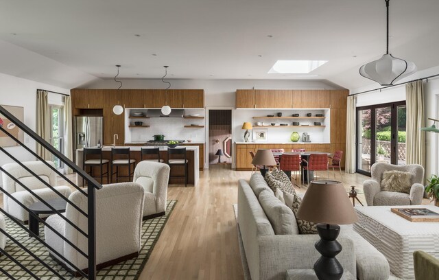 2300 Chickering Ln, Nashville, TN 37215 - living room with vaulted ceiling, a skylight, and light wood-type flooring