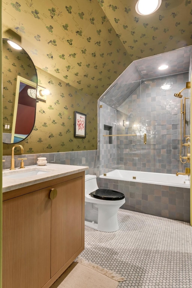2300 Chickering Ln, Nashville, TN 37215 - bathroom with wallpapered walls, vanity, tiled shower / bath combo, toilet, and tile walls