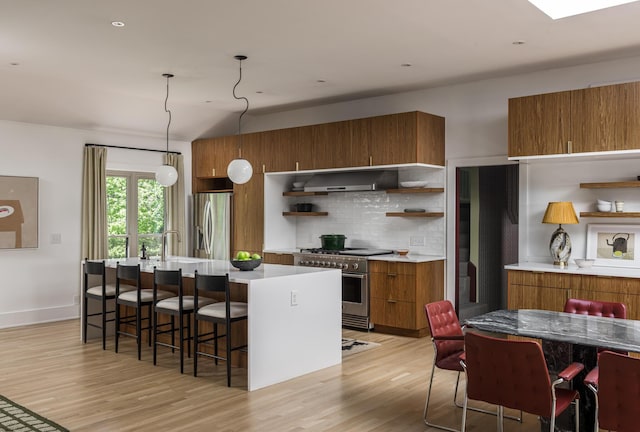 2300 Chickering Ln, Nashville, TN 37215 - kitchen with open shelves, stainless steel appliances, brown cabinetry, wall chimney range hood, and vaulted ceiling