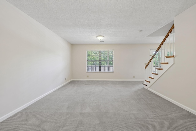 804 Beazer Ln, Antioch, TN 37013 - carpeted spare room featuring stairway, baseboards, and a textured ceiling