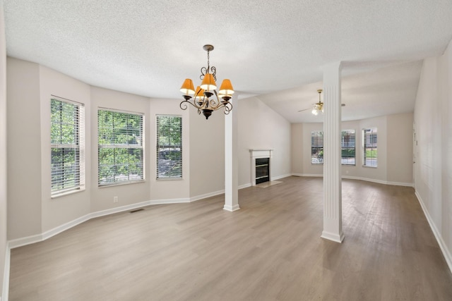 804 Beazer Ln, Antioch, TN 37013 - unfurnished living room with light wood finished floors, a textured ceiling, a chandelier, baseboards, and a fireplace with flush hearth