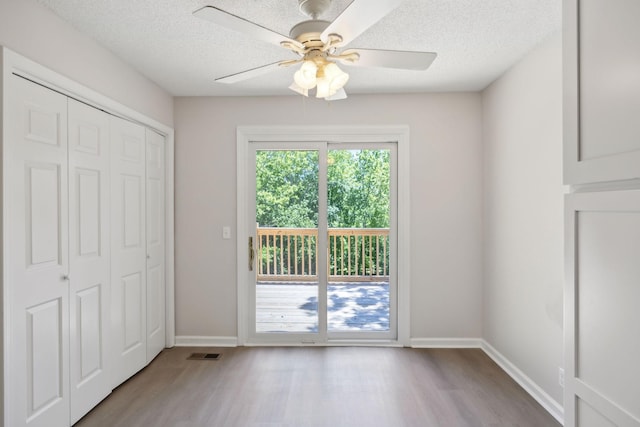 804 Beazer Ln, Antioch, TN 37013 - unfurnished bedroom with wood finished floors, baseboards, a textured ceiling, a closet, and a ceiling fan