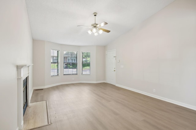804 Beazer Ln, Antioch, TN 37013 - unfurnished living room with a ceiling fan, light wood-style floors, a fireplace, and baseboards