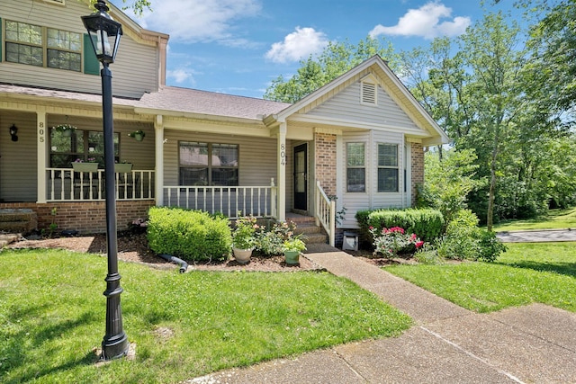 804 Beazer Ln, Antioch, TN 37013 - view of front of house with covered porch, a front lawn, brick siding, and a shingled roof