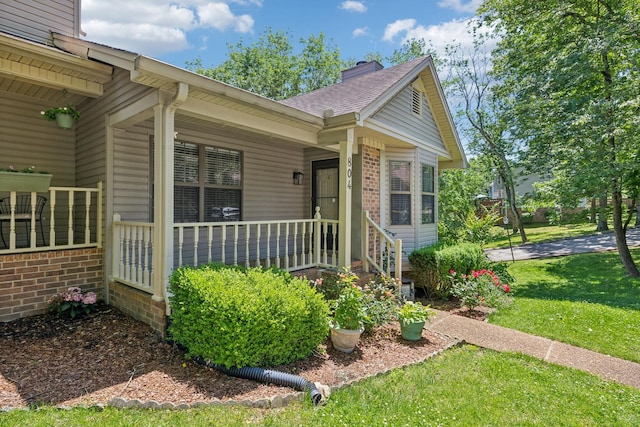 804 Beazer Ln, Antioch, TN 37013 - view of front of property featuring a chimney, a front lawn, covered porch, brick siding, and roof with shingles