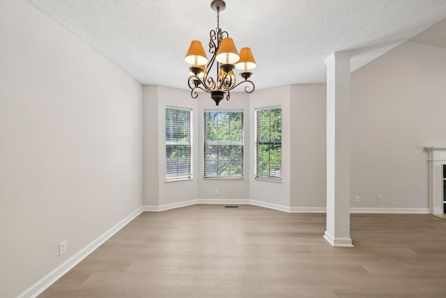 804 Beazer Ln, Antioch, TN 37013 - unfurnished dining area featuring light wood-style flooring, a chandelier, a textured ceiling, and baseboards