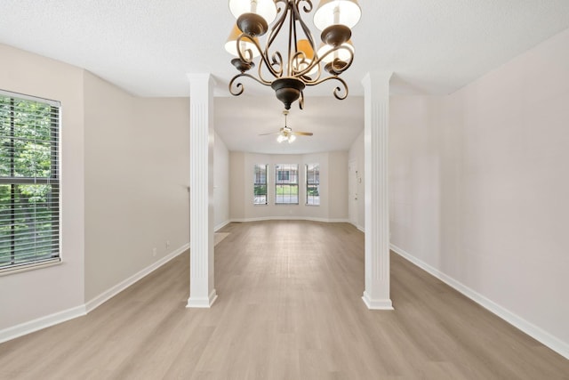 804 Beazer Ln, Antioch, TN 37013 - unfurnished living room with light wood-type flooring, a chandelier, baseboards, decorative columns, and a textured ceiling