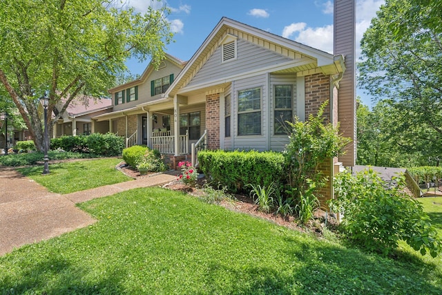 804 Beazer Ln, Antioch, TN 37013 - traditional home with brick siding, covered porch, a front lawn, and a chimney