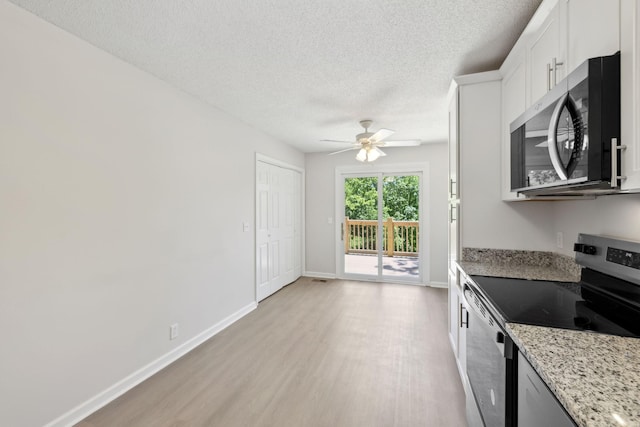 804 Beazer Ln, Antioch, TN 37013 - kitchen with appliances with stainless steel finishes, light wood finished floors, ceiling fan, a textured ceiling, and light stone countertops