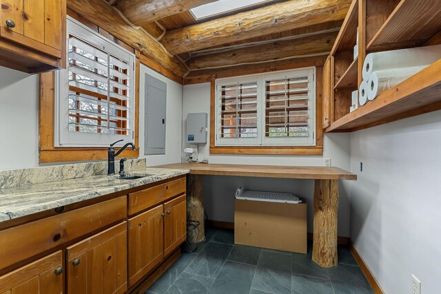 562 Rocky Ridge Rd E, Rock Island, TN 38581 - kitchen with a sink, electric panel, brown cabinetry, baseboards, and water heater